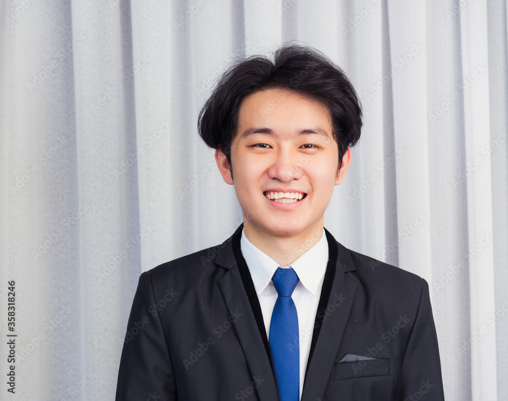 Portrait closeup of happy Asian young handsome manager professional business man laughing confident mature standing in suit smiling looking to camera with copy space Portrait closeup of happy Asian young handsome manager professional business man laughing confident mature standing in suit smiling looking to camera with copy space