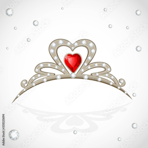 Golden tiara with diamonds and faceted red stone on white background