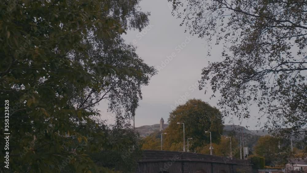 Handheld shot of the Old Stirling Bridge and the National Wallace Monument on background in UK Handheld shot of the Old Stirling Bridge and the National Wallace Monument on background in UK