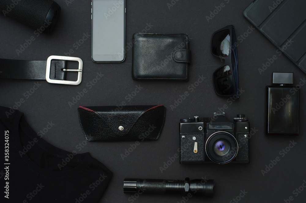 Flat lay composition with male accessories on black background