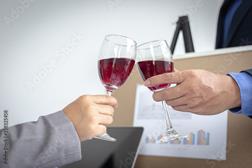 Both businessmen drink White to celebrate their financial and business success, Congratulate and celebrate concept.