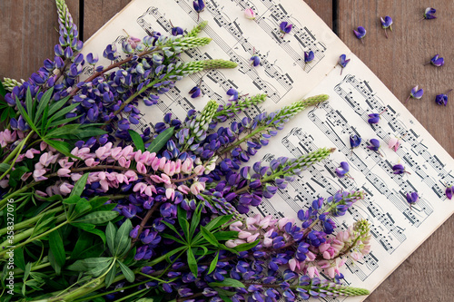 Bouquet of multi-colored lupins and notes. Background
