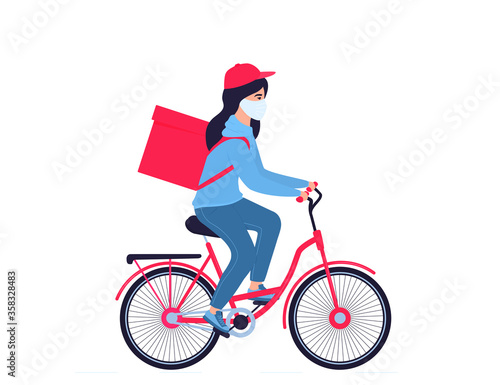 COVID-19. Quarantine. Coronavirus epidemic. Delivery girl in a protective mask carries food on a bicycle. Free shipping.