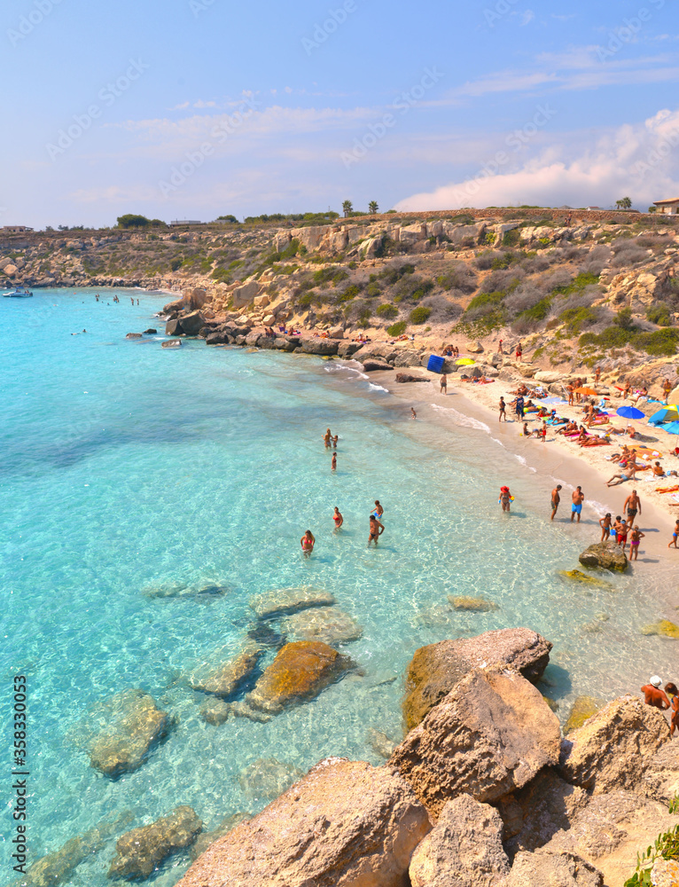  paradise clear turquoise blue water with rocks in Favignana island, Cala Azzura Beach, Sicily South Italy.