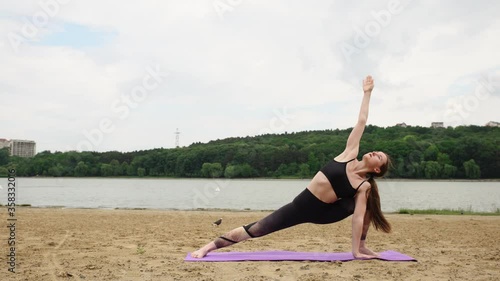 Young woman doing yoga in the city park