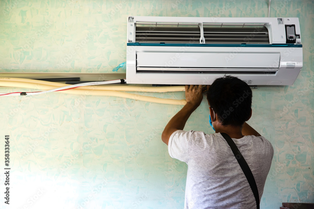 Air Technician is wiring and installing brand new Air Conditioner