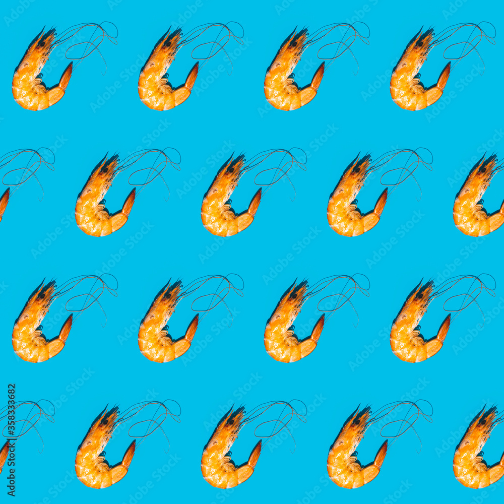 Food diagonal seamless pattern of shrimps on blue background. Creative minimalist flat lay with hard light. Food diagonal seamless pattern of shrimps on blue background. Creative minimalist flat lay with hard light.