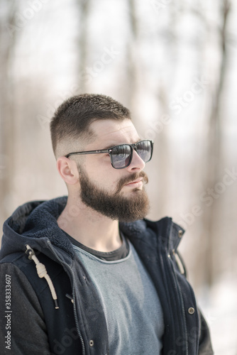 portrait of a bearded young man in winter