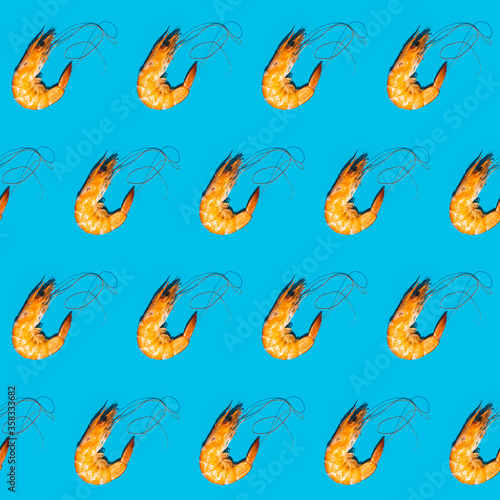 Food diagonal seamless pattern of shrimps on blue background. Creative minimalist flat lay with hard light. © Victoria Kondysenko