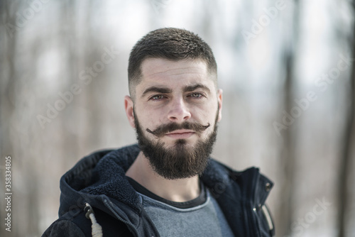 portrait of a bearded young man in winter