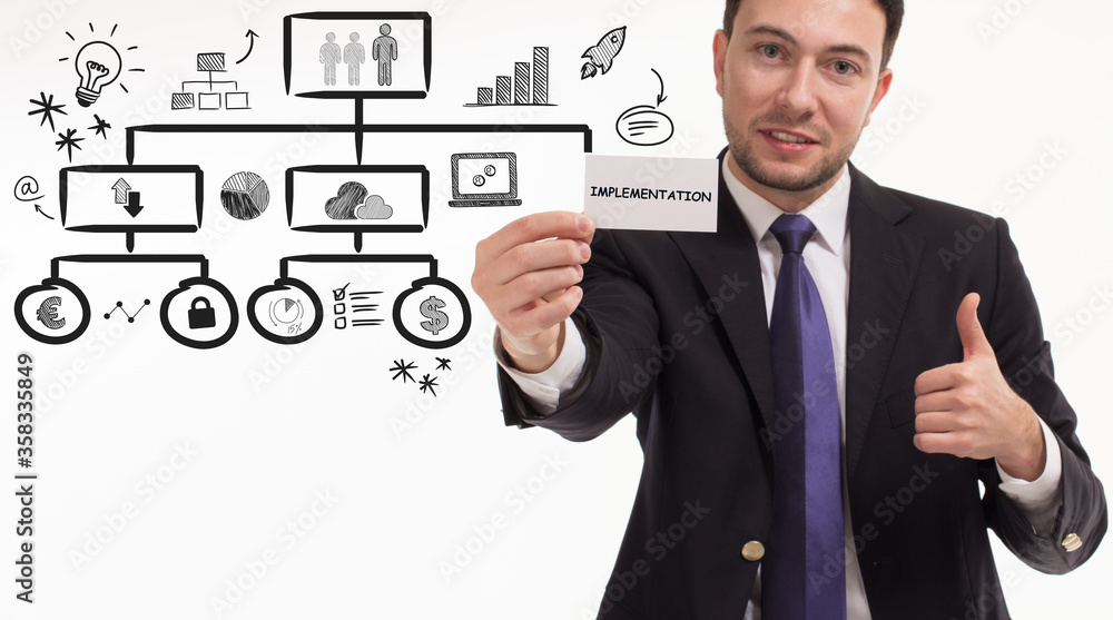 Business, technology, internet and network concept. Young businessman thinks over the steps for successful growth: Implementation Business, technology, internet and network concept. Young businessman thinks over the steps for successful growth: Implementation