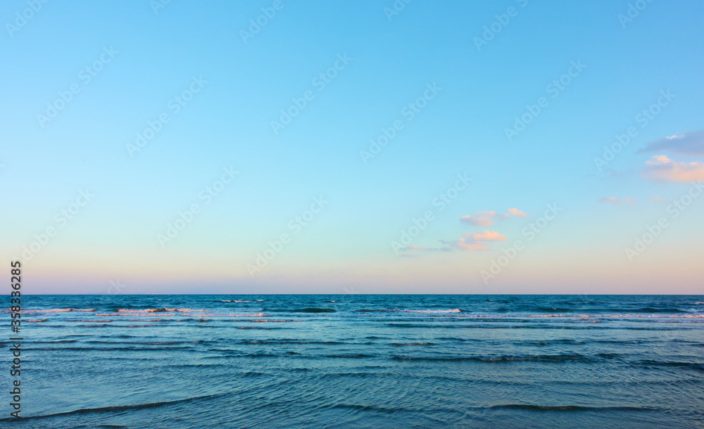 Fototapeta premium Sea with clear horizon and blue sky with clouds - background