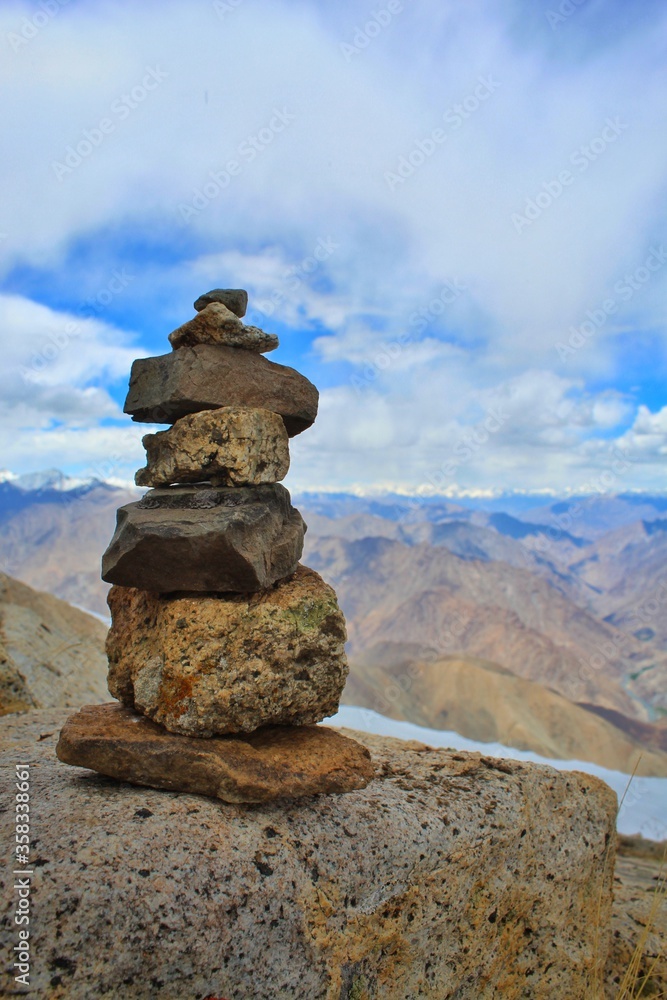pieces of stones balancing over another as a symbol of peace of mind and balance.