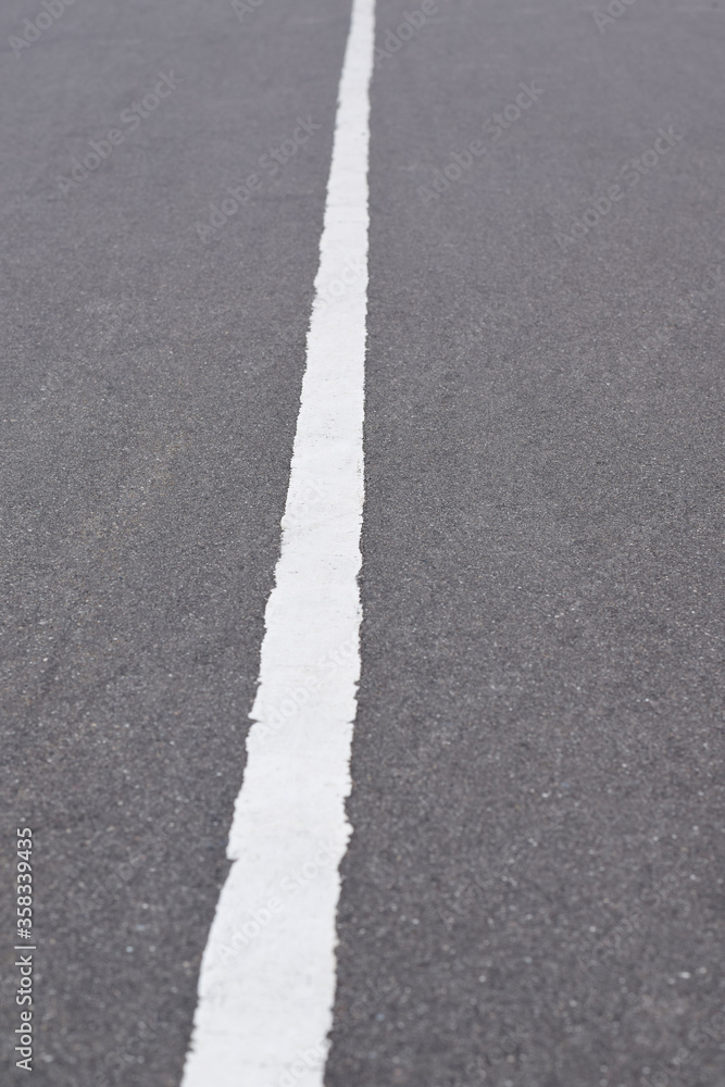 White solid line on asphalt road. Carriageway marking White solid line on asphalt road. Carriageway marking