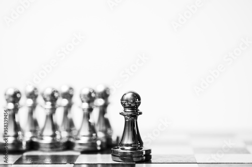 A chess pawn outstanding stand at front. leadership concept.