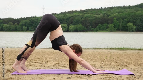 Young woman doing stretching exercise in the park