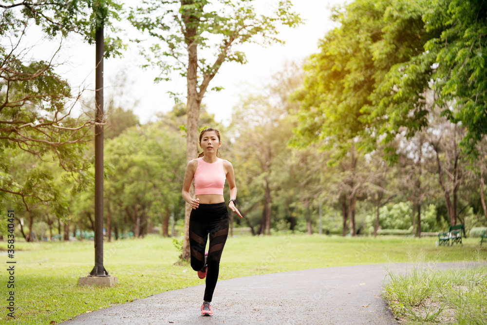 Lifestyle Happy Asian women is running in the great outdoors or the beautiful nature park. Enjoying the physical activity in the summer. Concept Workout