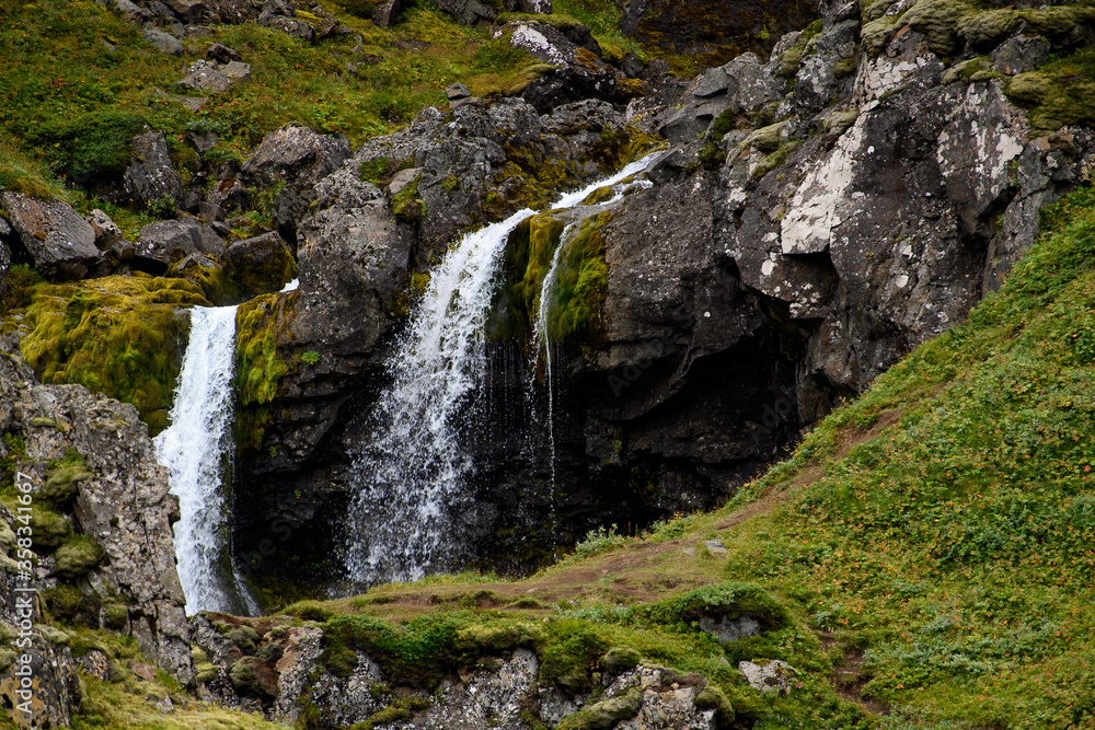 Klifbrekkufossar, beautiful row of waterfalls, in Mjoifjordur village, Iceland