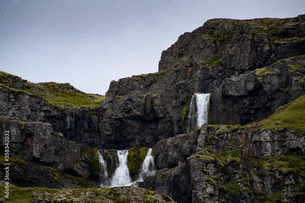 Little waterfall Klifbrekkufossar in Mjoifjordur, Iceland