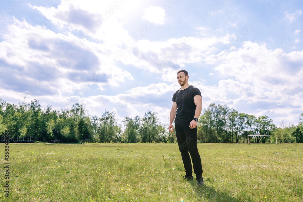 Strong muscular athlete with beard warms up Strong muscular athlete with beard warms up