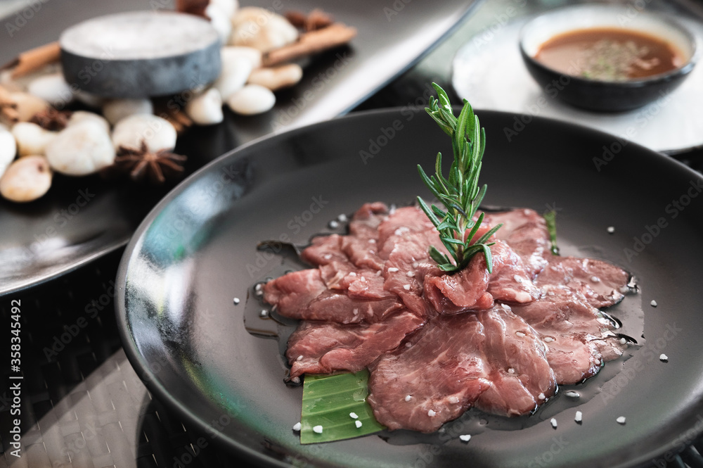 Sliced juicy raw lamb meat, cooking ingredient. preparing for grill on a hot rock.