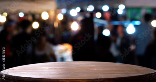 Empty wooden blur lighh and person in party background.     © v.stock