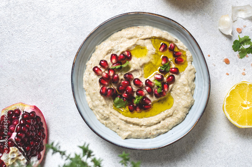 Levantine appetizer Baba ghanoush baked eggplant appetizer served with pomegranate seeds photo