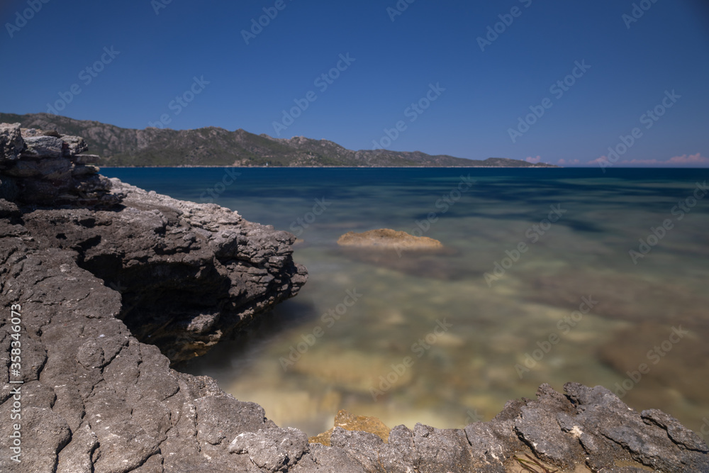 Long exposure of a rocky beach on the Mediterranean Sea, in Corsica