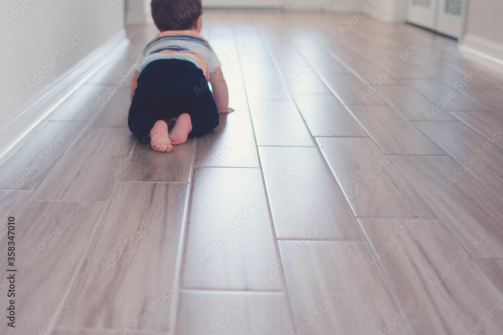 Baby playing crawling on the floor stock photo royalty free 