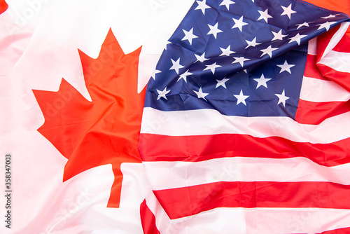 Natural fabric Canada and USA flags as background, Canadian and American flags, top view