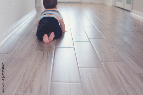 Baby playing crawling on the floor stock photo royalty free 