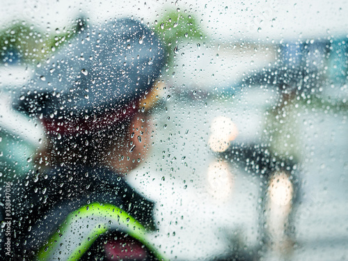 Photography policewoman on traffic security in rainy weather