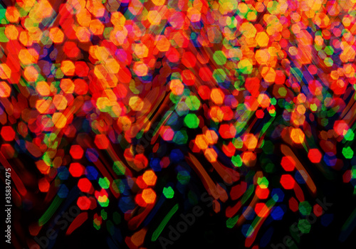 Festive bokeh abstract in multicolor on black