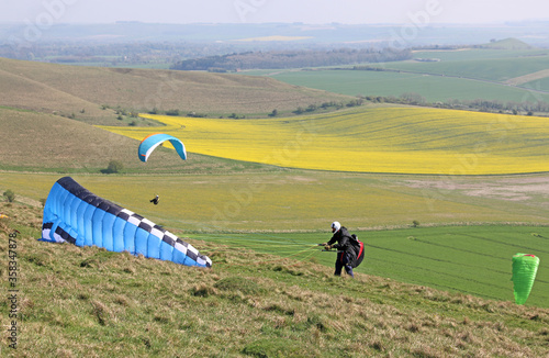 Paragliders flying and preparing wings at Milk Hill, Wiltshire	