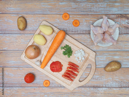 Ingredients for soup with chicken and potato ,carrot ,tomato ,onion.
