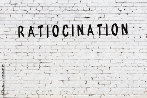 Word ratiocination painted on white brick wall