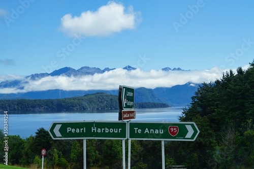 Highway 95 roadsign - Pearl Harbour - Te Anau - Lake Manapouri in background