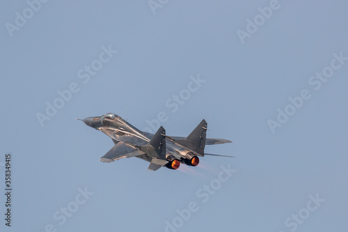 Air force jet fighter showing afterburner flames during aerobatic display