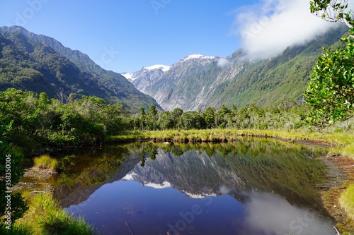 Fototapeta Naklejka Na Ścianę i Meble -  Lake Matheson - panorama view Mt. Cook and Mt. Tasman - reflection.