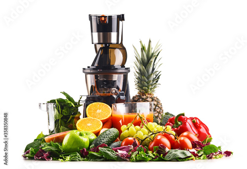 Slow juicer with organic fruits and vegetables isolated on white photo