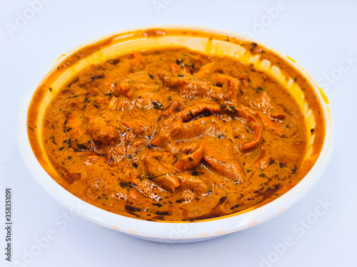 Indian food in takeout container, Chicken tikka masala in takeaway plastic bowl on white background for eat at home, Delivery food.