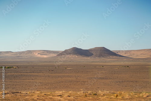 bleak desert landscape with mountain and rock formations