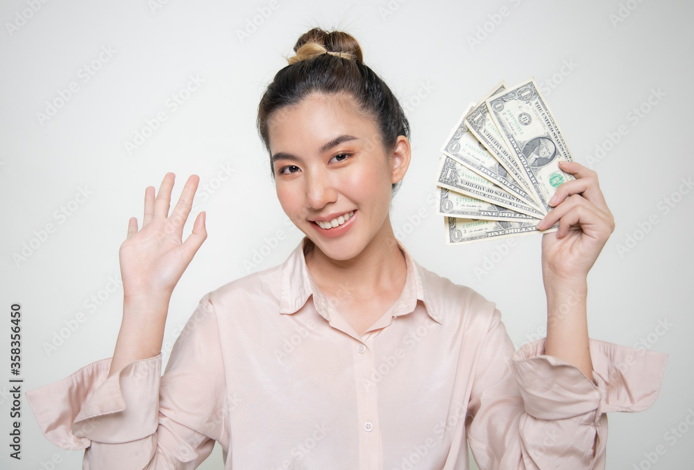 Asian woman holding money, showing off white back Asian woman holding money, showing off white back