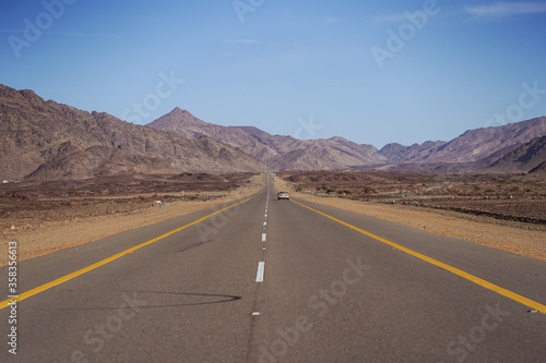 beautiful straight highway surrounded by rock mountains © Juan Alberto Ruiz