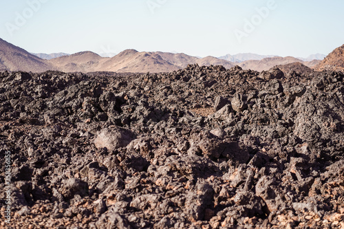 zone of black volcanic rocks in the middle of the desert