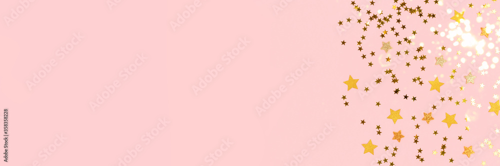 Banner with golden stars confetti on a pink pastel background. Shiny composition with copy space.