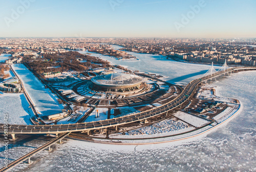 Beautiful winter snowy aerial drone view of the Gulf of Finland, Saint-Petersburg, Petrogradsky and Primorsky district, Russia, with a stadium, western rapid diameter and cable-stayed bridge