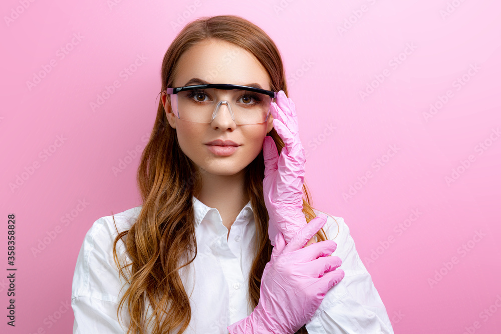 Girl in safety glasses and gloves on pink background Girl in safety glasses and gloves on pink background