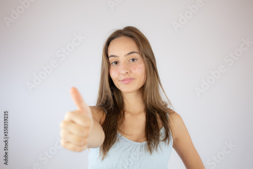 Wallpaper Mural Pretty young girl making finger up gesture Torontodigital.ca