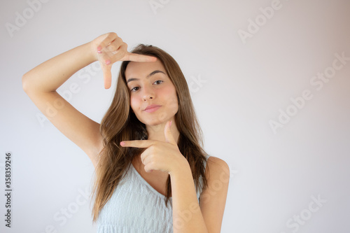 Pretty young girl making portrait gesture